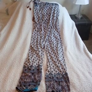 Colorful jumpsuit with leather ties.